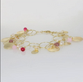 bracciale con charms, perle e pietre fucsia